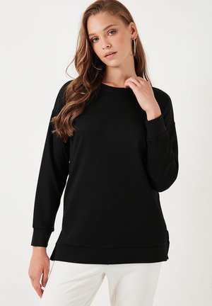 Black sweatshirt with long sleeves, round neckline, and a relaxed fit. Smooth texture, subtle shine, and ribbed cuffs and hem.