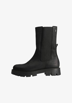 Black leather mid-calf boot with chunky sole, elastic side panel, pull tab at the heel, and embossed text near the sole.