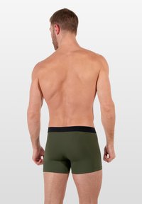 Olive green men's boxer shorts with a black elastic waistband, featuring a smooth texture and minimalist design, viewed from the back.