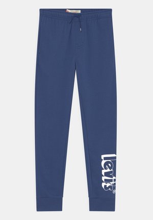 Blå joggingbukser med elastisk talje og snøre, ribbet kant, sidelommer og stort hvidt Levi's-logo på den nederste venstre ben.