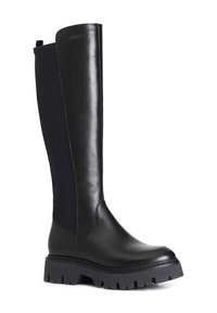 Bota negra hasta la rodilla que presenta paneles de cuero suave y textil, una suela de goma gruesa y una puntera redondeada. Cuenta con una lengüeta lateral.