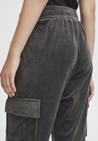 Grijze fluwelen cargobroek met een elastische tailleband, zijzakken en een zachte textuur met een ontspannen pasvorm.