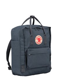 Dark blue backpack made of durable fabric with a rectangular shape. Features a front zip pocket, logo patch, and adjustable shoulder straps.