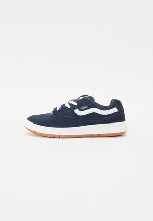Navy blue suede sneaker with white accents, lace-up design, and a cushioned white midsole. Features a gum rubber outsole.