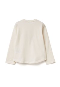 Halenka s dlouhým rukávem v krémové bavlně, se zaobleným výstřihem, rounded hem a manžetami. Hladká textura, minimální šití na švech.