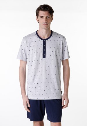 Set di pigiama da uomo con maniche corte, composto da una maglietta grigia a pois con colletto e bottoni blu navy, abbinata a pantaloni corti blu navy. Materiale in cotone morbido.