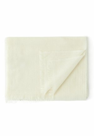 Écharpe en beige clair avec franges, offrant une texture douce et présentant un coin replié révélant des coutures délicates et une finition nette et lisse.