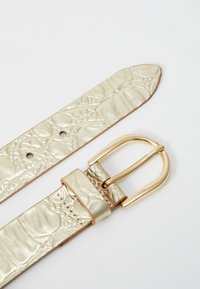 Metallic gold belt with embossed texture. Features a gold-tone buckle and five adjustment holes, with a smooth leather backing.