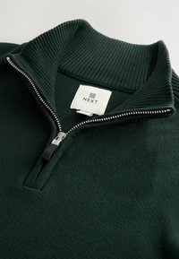 Dunkelgrüner Pullover mit einem gerippten Kragen und halbem Reißverschluss. Verfügt über einen strukturierten Stoff und ein Etikett mit "NEXT", das auf der Innenseite angebracht ist.