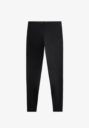 Schwarze Leggings aus dehnbarem Stoff, mit einem schlichten Design und einer figurschmeichelnden Silhouette, hoher Taille und nahtloser Verarbeitung.