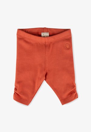 Baby-Leggings in Rostfarbe mit gerafften Bündchen und einem kleinen runden Logo-Patch am oberen rechten Bein, flach auf weißem Hintergrund liegend.