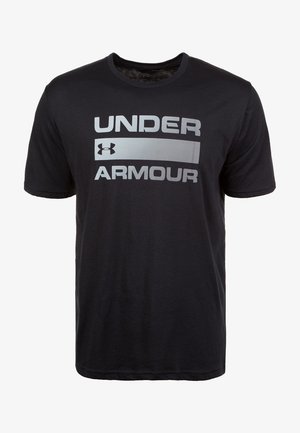 Must mustelane T-särk, millel on julge hall "UNDER ARMOUR" logo rinnal. Lühikesed varrukad ja ümar kaelus. Pehme tekstuur.