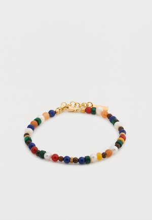 Náramok so zlatou sponou s malými guľatými korálkami v modrej, červenej, zelenej, bielej, oranžovej a hnedej farbe usporiadanými v vzore.