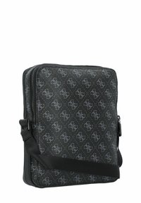 Borsa a tracolla in pelle nera con un motivo geometrico, dotata di chiusura con zip, tracolla regolabile e superficie liscia.