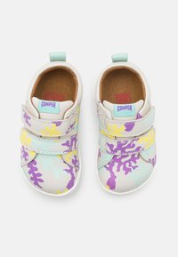Children's sneakers with a white and pastel color scheme, featuring purple, yellow, and turquoise coral patterns, hook-and-loop straps, and a textured surface.