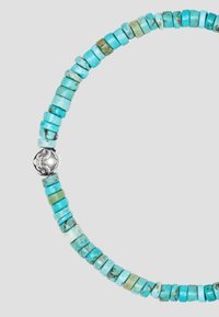 Turquoise beaded necklace featuring cylindrical stones in various shades of blue and green, accented with a silver decorative clasp.