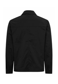 Chemise noire à manches longues avec col, poignets boutonnés et détail de couture sur la partie supérieure du dos, vue de dos.