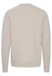 Light beige sweatshirt, cotton blend, crew neck, long sleeves, ribbed cuffs and hem, smooth texture, simple design, no visible branding.