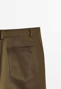 Brown textured trousers featuring a back pocket and belt loops, made of a durable fabric with a subtle herringbone pattern.
