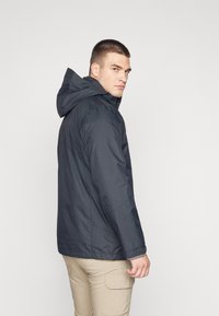 Navy blue, waterproof jacket with a hood, featuring a zip closure, contrasting gray interior, and elastic cuffs. Minimalist design.