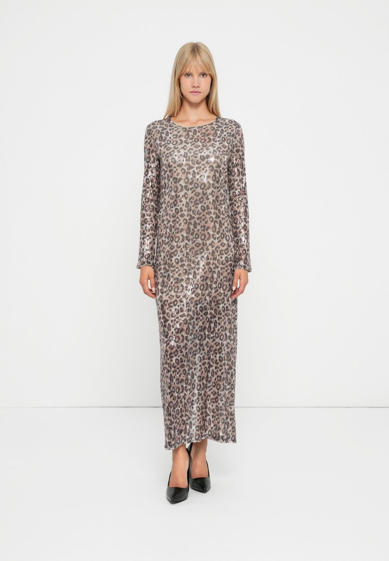 Langarm maxi kjole med leopardmønster, laget av skinnende stoff. Har en rett silhuett og rund hals. svarte høye hæler.