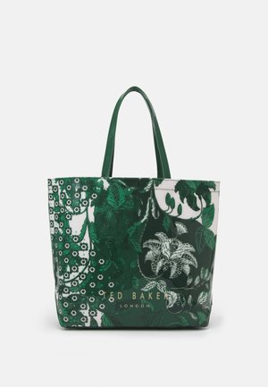 Groene en witte tas met bloemenpatroon, twee handvatten en gouden letters "Ted Baker London" aan de voorkant.
