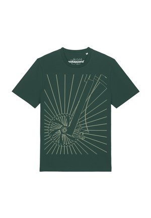 T-shirt vert foncé avec un dessin au trait beige représentant un pédalier, une pédale, et des rayons irradiant à l'avant.