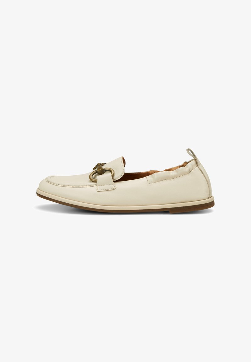 Cream leather slip-on shoe with a rounded toe, featuring a decorative bronze hardware accent and a textured sole. No laces, casual design.