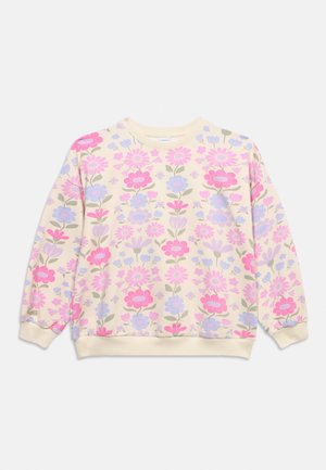 Kremna jopica s potiskom rož v rožnati, vijolični in zeleni barvi, dolgimi rokavi ter rebrastimi manšetami in spodnjim robom.