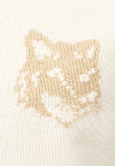 Krém háttérrel rendelkező, bézs és fehér kötött gyapjú anyag, amely stilizált rókaarc mintát tartalmaz.