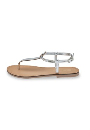 Flat sandal with a silver metallic strap design, featuring a padded beige insole and a buckled ankle closure. Lightweight and minimalistic.