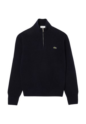 Marineblauwe gebreide trui met een ritskraag, geribde manchetten en zoom. Heeft een klein groen Lacoste-logo op de borst.