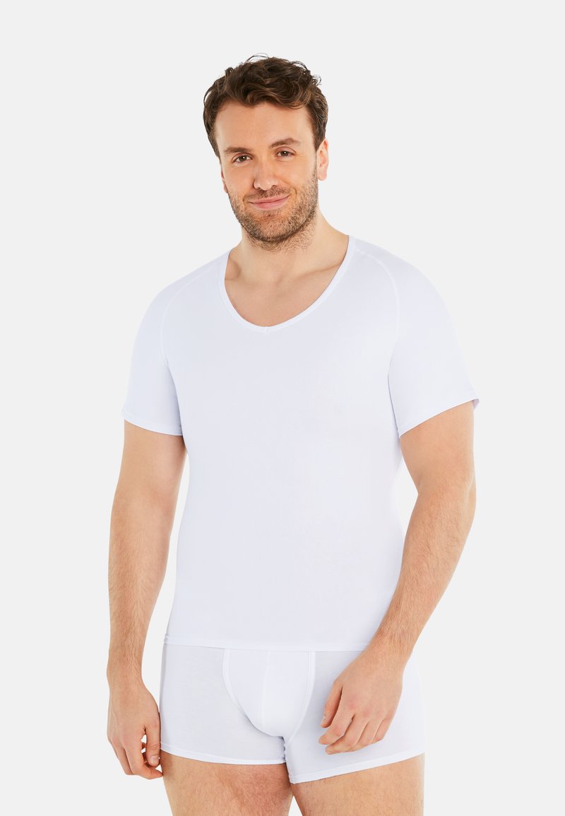 White short-sleeve top with a V-neck design, made from a smooth cotton blend, paired with matching white boxer shorts.