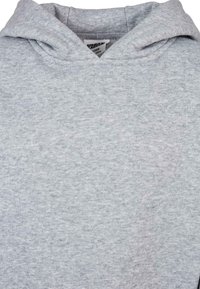 Grauer Kapuzenpullover aus weichem, strukturiertem Fleece. Verfügt über eine Kängurutasche und eine auffällige Kapuze mit verstärkten Nähten.