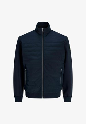 Veste matelassée bleu marine avec fermeture éclair intégrale à l'avant, poches latérales zippées, poignets et ourlet côtelés, et col montant.