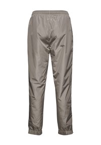 Lätta byxor med elastisk midja i en dämpad taupefärg. Slät, vattenavvisande nylon i tyg med resår i bensluten för en avslappnad passform.