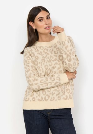 Beige tröja med leopardmönster, ribbade ärmslut och nederkant, mjuk textur, rund halsringning. Kombinerad med mörka jeans.