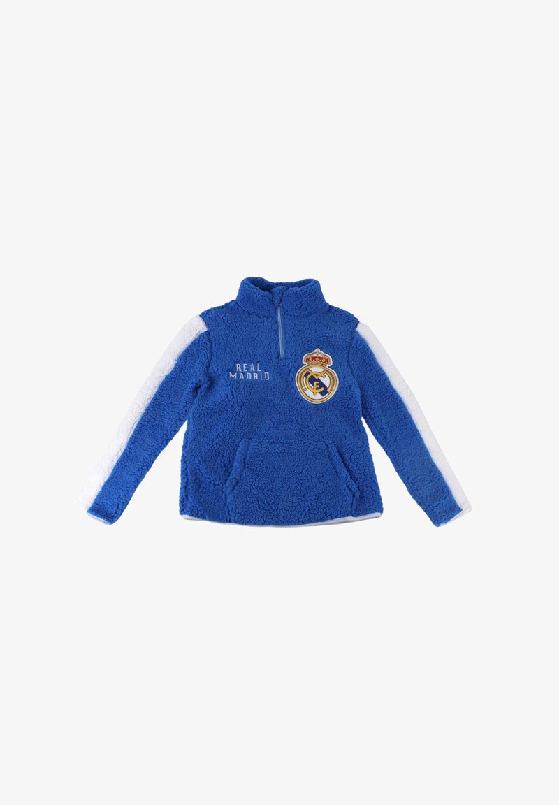 Pullover in pile blu con zip a metà, accenti bianchi sulle maniche, testo "REAL MADRID" e stemma ricamato sul petto. Tessuto morbido e testurizzato.