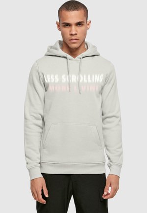 Light gray hoodie with a front kangaroo pocket and drawstring hood. Features bold white text that reads "LESS SCROLLING MORE LIVING."