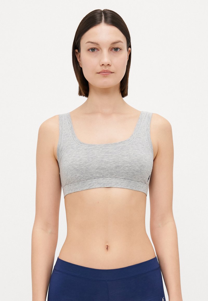 Gray cotton sports bra with wide straps, a rounded neckline, and a seamless design. Textured fabric, snug fit, and minimalist style.