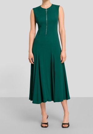 Groen mouwloze jurk met een rits aan de voorkant en een ronde trekker, een vloeiende rok tot op de knie, gemaakt van gladde stof met een lichte textuur.