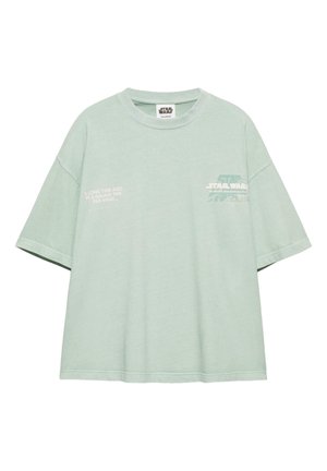 Jasnozielona koszulka Star Wars z krótkimi rękawami, okrągłym dekoltem i białym nadrukiem na klatce piersiowej oraz lewej stronie.