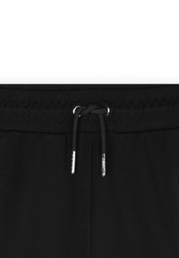 Zwarte joggingsbroek met een elastische tailleband met een koord, metalen tips en zijzakken. Gladde stof en gestroomlijnd ontwerp.