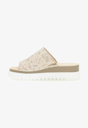 Slide sandal with a patterned beige upper, light-colored sole, and a chunky, ridged white outsole. Open-toe design with a mid-height platform.
