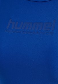 Blue athletic shirt with a smooth, fitted texture. Features embossed "hummel PERFORMANCE" logo in a darker blue, minimalistic design.