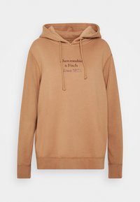 Brun huva sweatshirt i mjukt tyg, med känguruficka, snoddar och frontlogotekst i en mörkare nyans. Avslappnad passform.