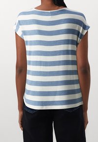 Striped t-shirt in blue and white, short sleeves, rounded neckline, soft texture, slightly curved hem, loose fit, casual design.