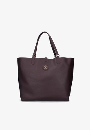 Borsa tote in pelle marrone scuro con due manici e un piccolo emblema circolare dorato al centro anteriore.