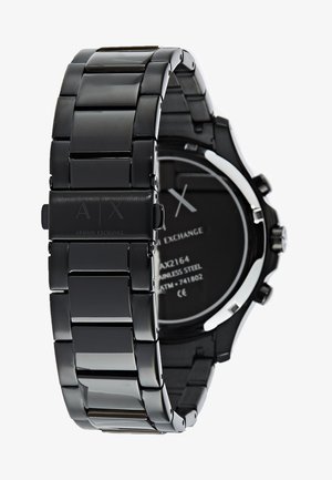 Schwarze Edelstahl-Uhr mit einem schlanken, segmentierten Armband; verfügt über ein rundes Ziffernblatt mit silbernen Akzenten und einem minimalistischen Design auf dem Zifferblatt.