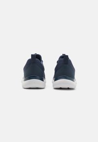 Navy athletic shoes with a smooth synthetic upper and textured heel, featuring a white rubber sole and pull tabs at the back for easy wear.